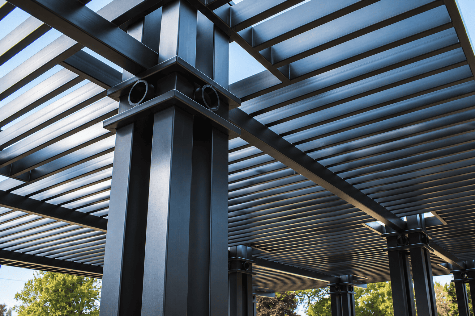 Close-up of a modern aluminum louvered patio cover structure with adjustable-style roof slats